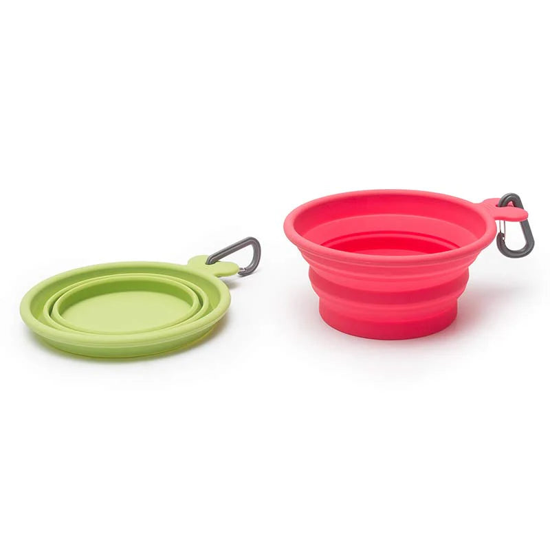 Green and pink collapsible silicone pet bowls on a white background