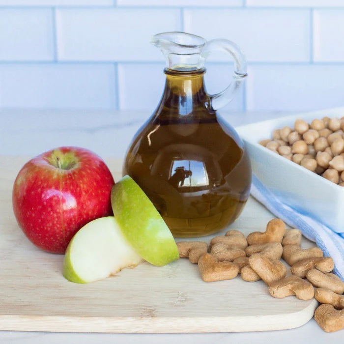 Apple crunchy dog treat ingredients on a cutting board in a kitchen