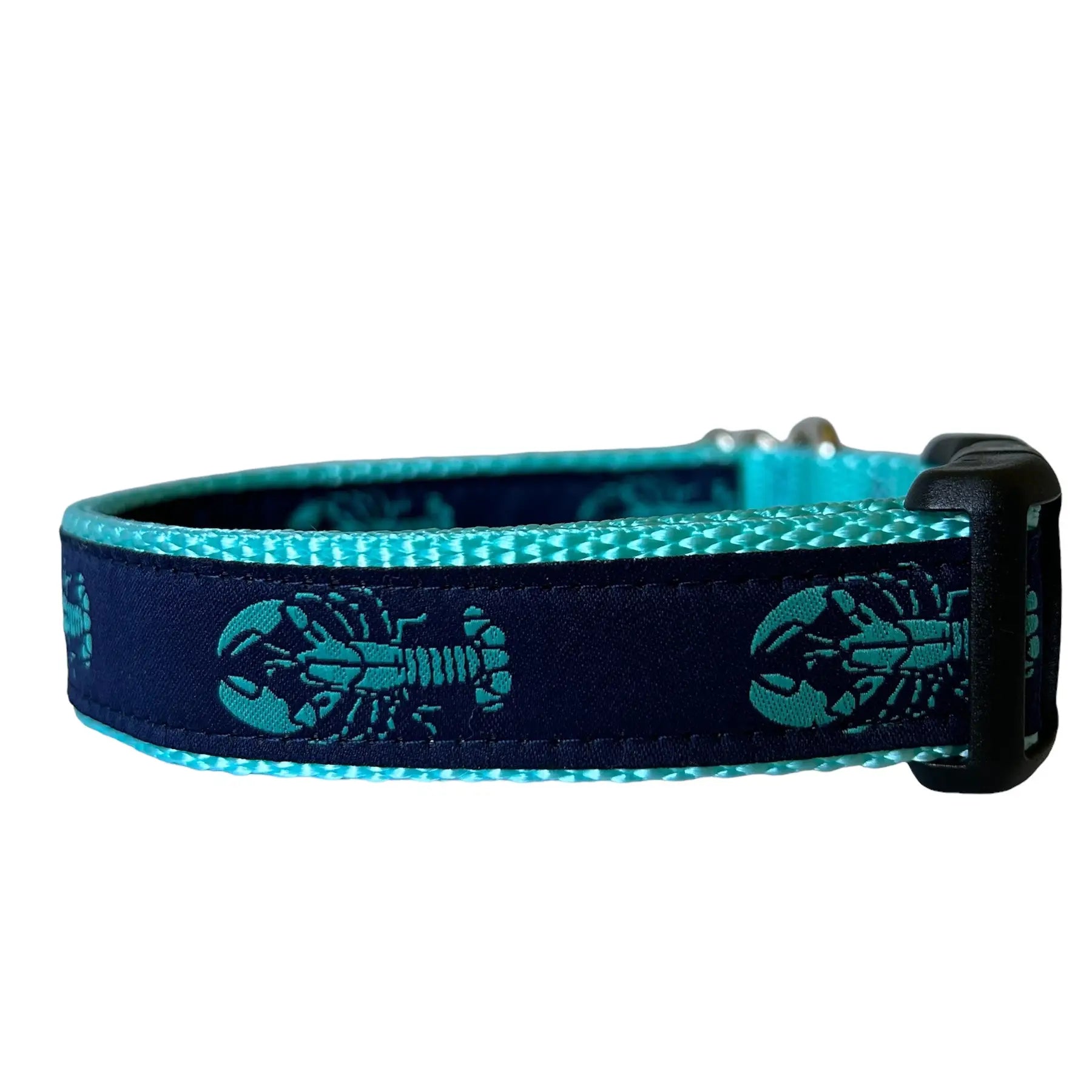 Adjustable nylon webbing dog collar featuring a repeating teal lobster pattern stitched onto a dark navy blue ribbon background, attached to bright teal webbing with a black plastic buckle.