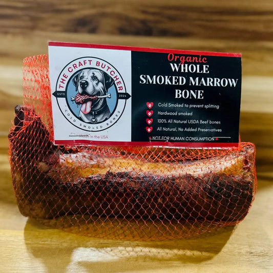 Organic whole smoked marrow bone with packaging on a wooden surface