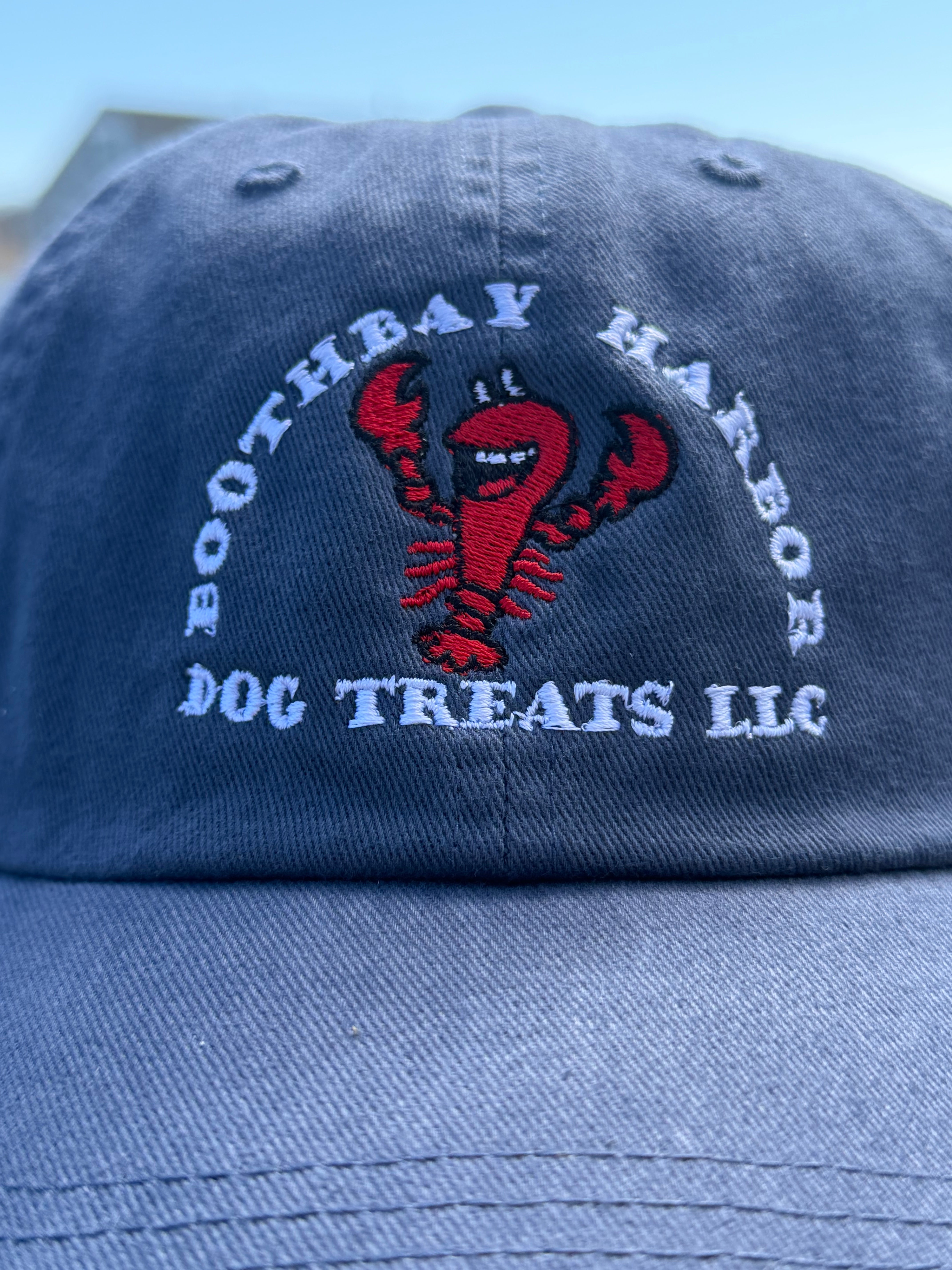 close up of Blue Boothbay Harbor Dog Treats dad hat with embroidered red lobster logo