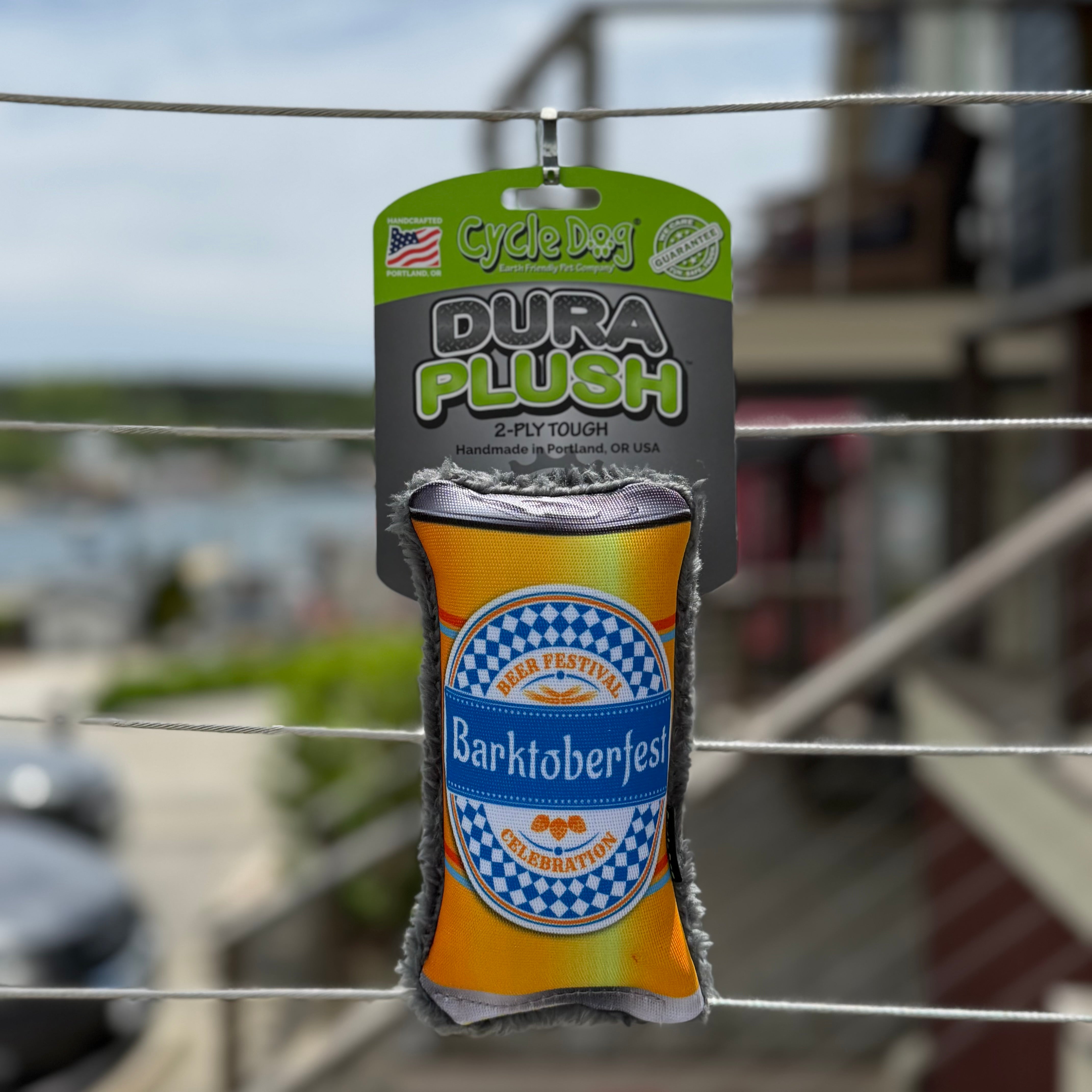 Dura Plush toy shaped like a beer can with 'Barktoberfest' branding.
