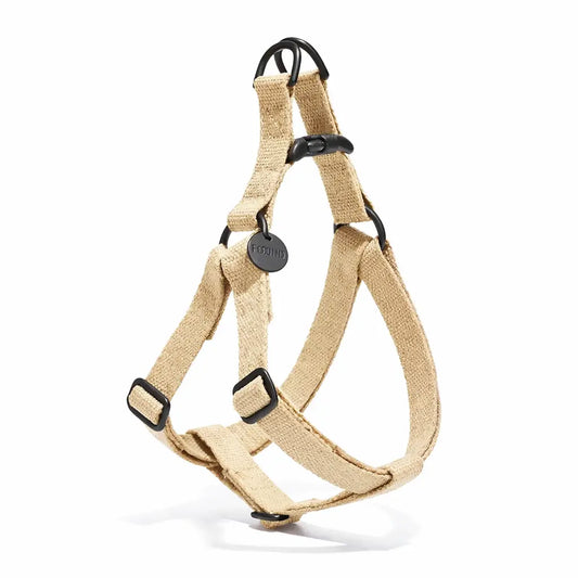 Beige canvas dog harness with black hardware on a white background